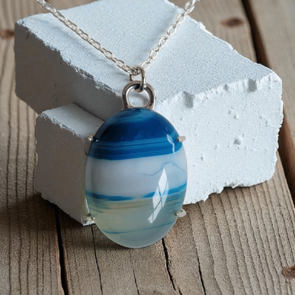 Blue polished stripe agate stone set in a 4 claw sterling silver setting